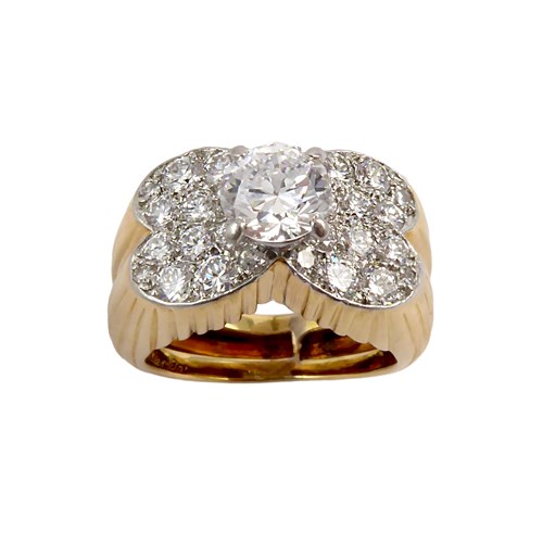 Diamond and yellow gold ring by Cartier, Paris, with a central round brilliant cut diamond of approximately 0.70ct, claw set and raised upon a diamond cluster panel of butterfly outline,